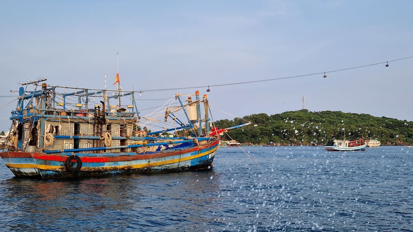 An old wooden fishing boat at sea